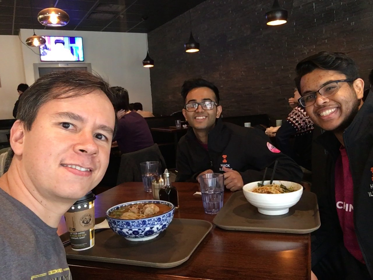 Pablo (left) has lunch with Shreyas and Kavi from HackIllinois staff (right) at Mid Summer Lounge