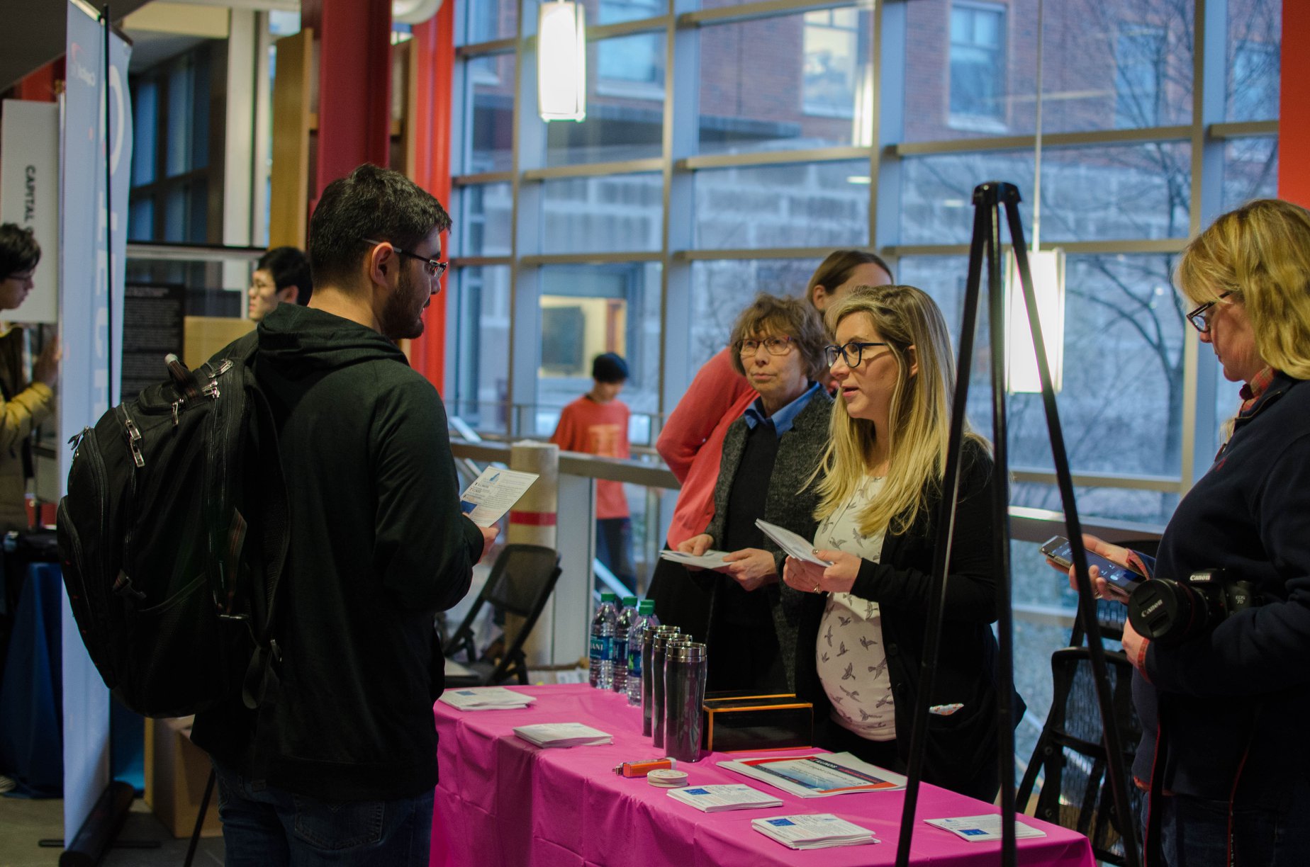 A student and sponsor representatives chat at the company expo