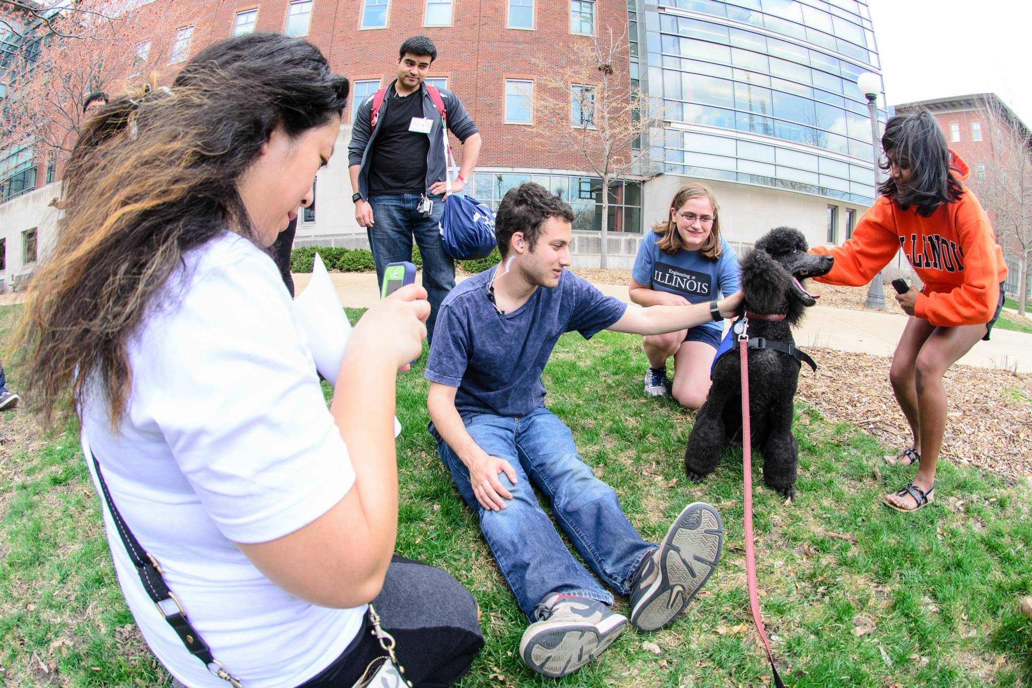 HackIllinois staff and attendees de-stress with therapy dogs (Space Puppies<sup>TM</sup>) outside of Siebel. Photo by Priten Vora.